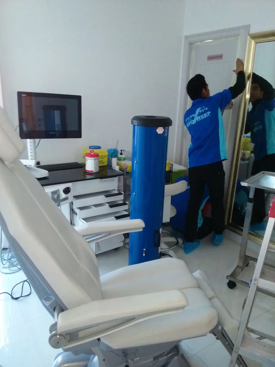 A BioSweep technician working in a dental treatment room alongside professional equipment.